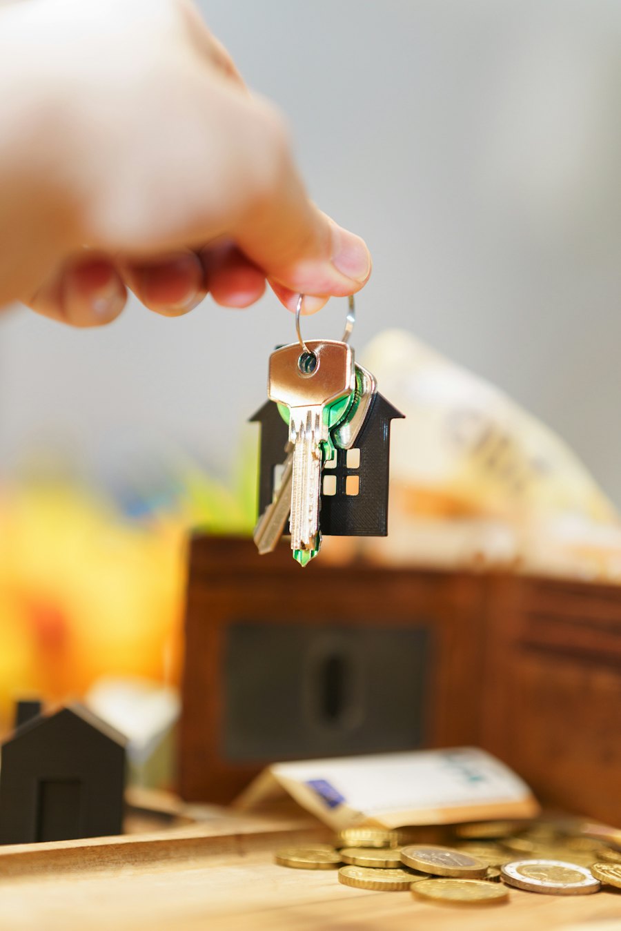 A hand holding a set of house keys